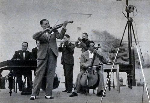 Grigoraș Dinicu playing violin in front of his orchestra in the 1920s.